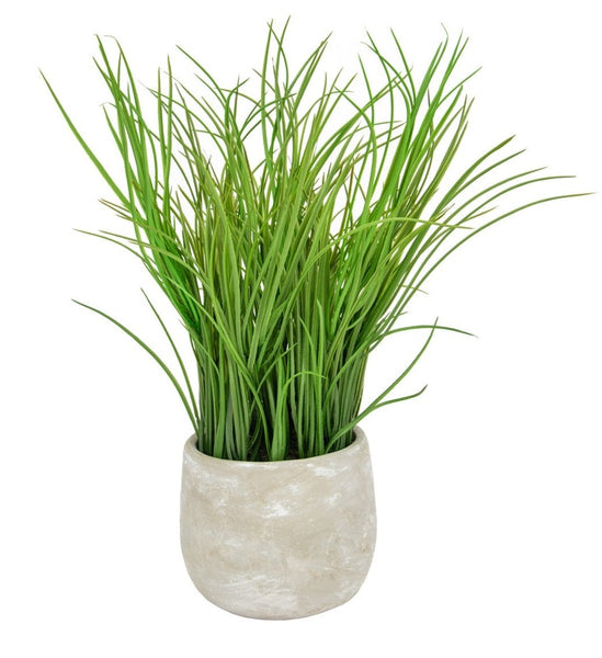 Artificial potted grass plant in distressed grey cement pot